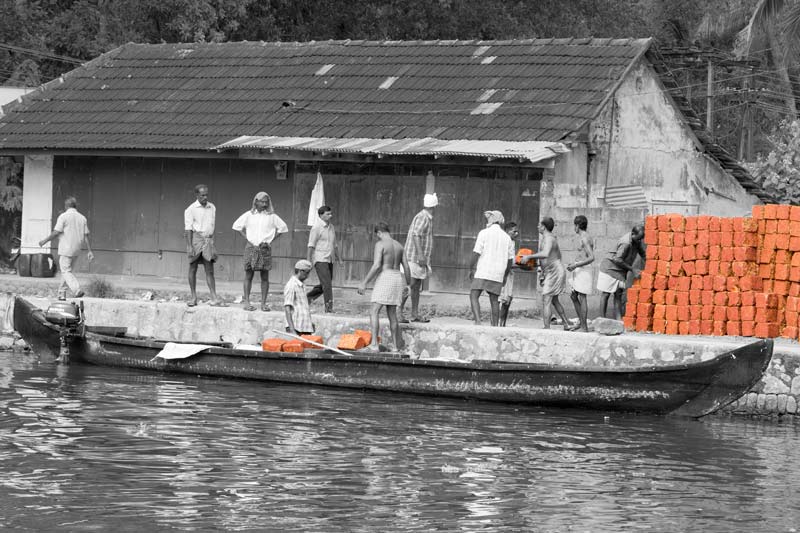 Living Below the Sea Level - Bricks for construction work being transported by a small motorized boat in Alappuzha district, Kerala